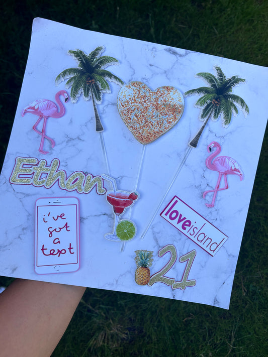 Personalised “I’ve Got a Text” Love Island cake topper with gold heart, tropical drink, and pineapple decorations.