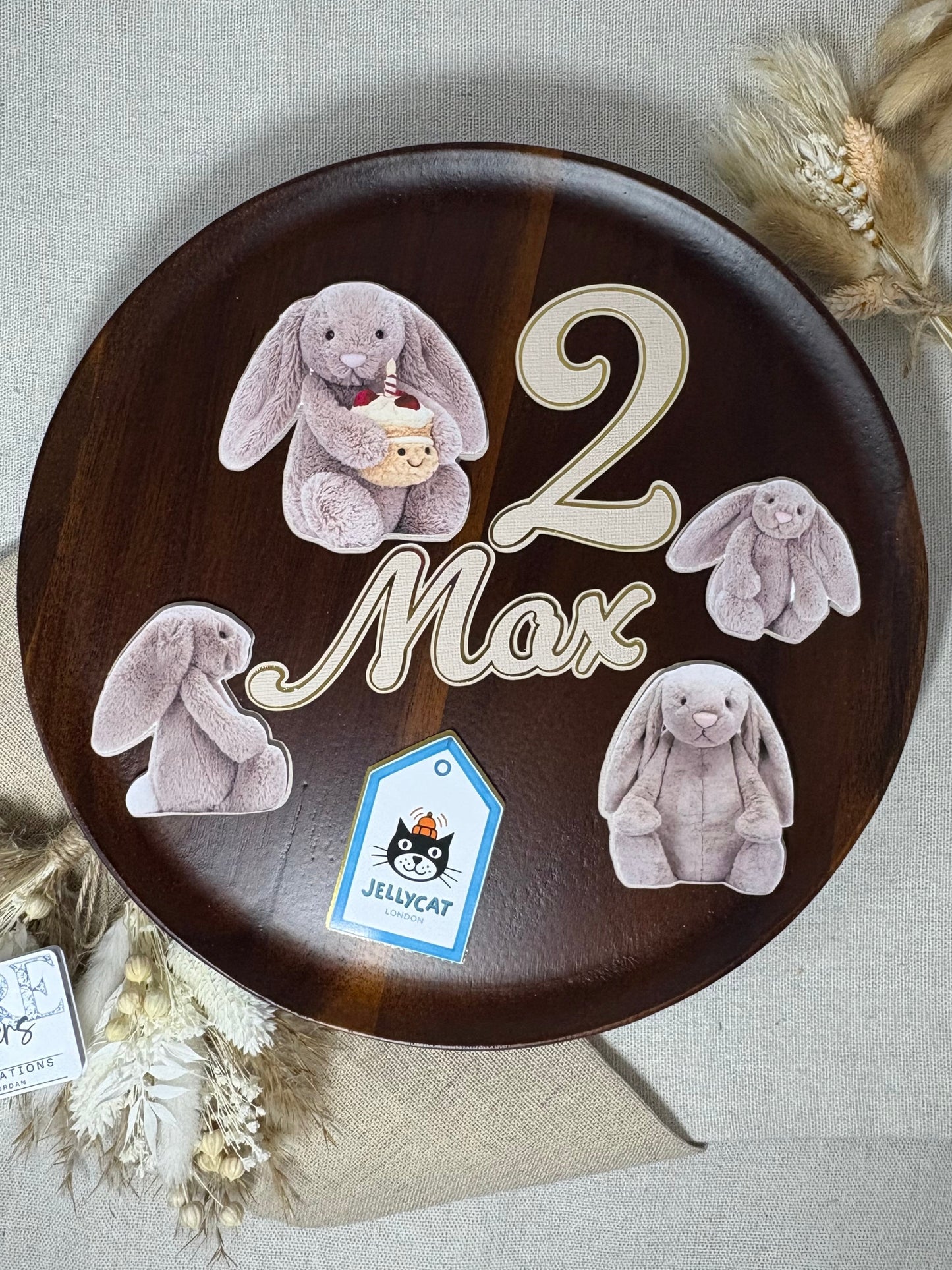 Decorative plate with teddy bear designs and text on a textured surface