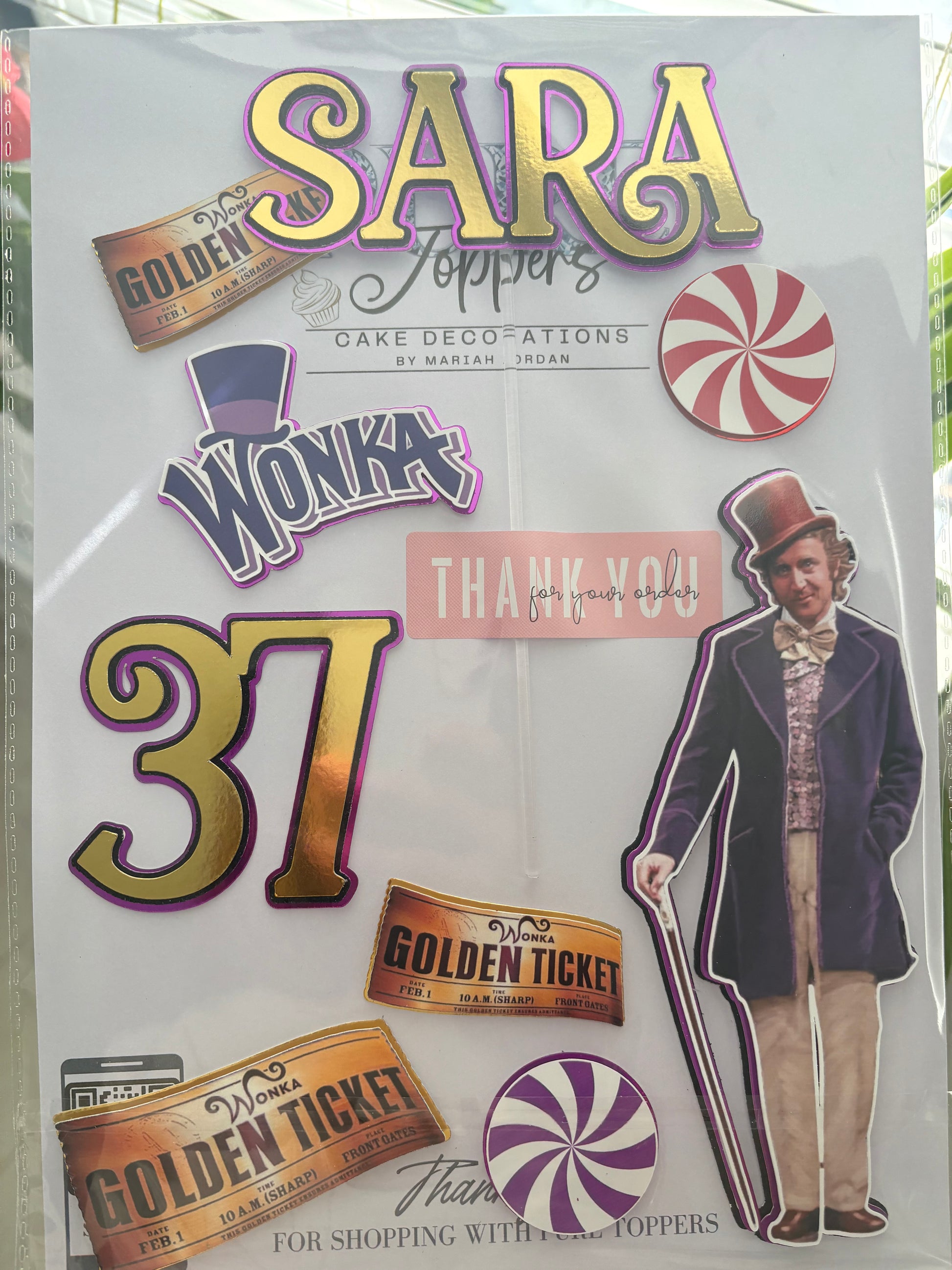 Personalised Willy Wonka Cake Topper Set with name and age charm, golden tickets, Willy Wonka figure, candy decorations, and sticks for birthday cake