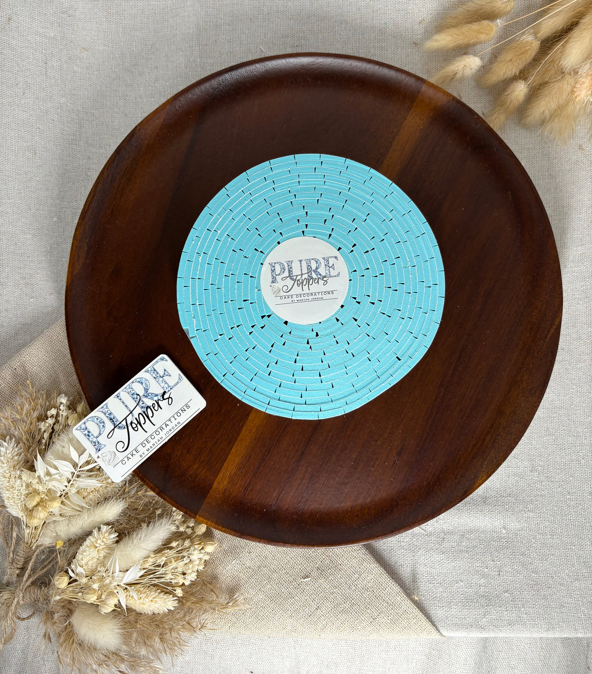 Adhesive foam pads creating dimension between layered cardstock decorations