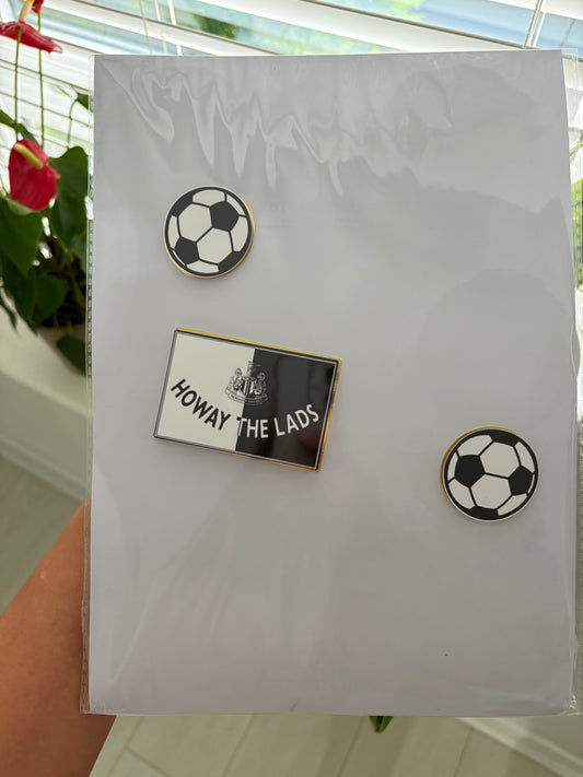 Layered Newcastle United football badge cake charm, perfect for adding detail to a football-themed birthday cake.