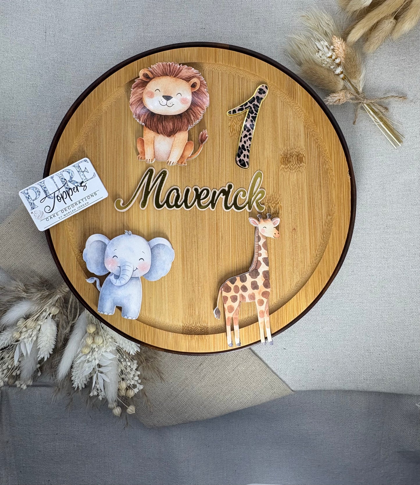 Round wooden plaque with animal illustrations and text on a neutral background