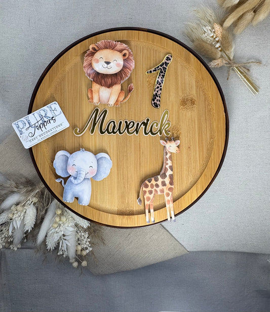 Round wooden plaque with animal illustrations and text on a neutral background