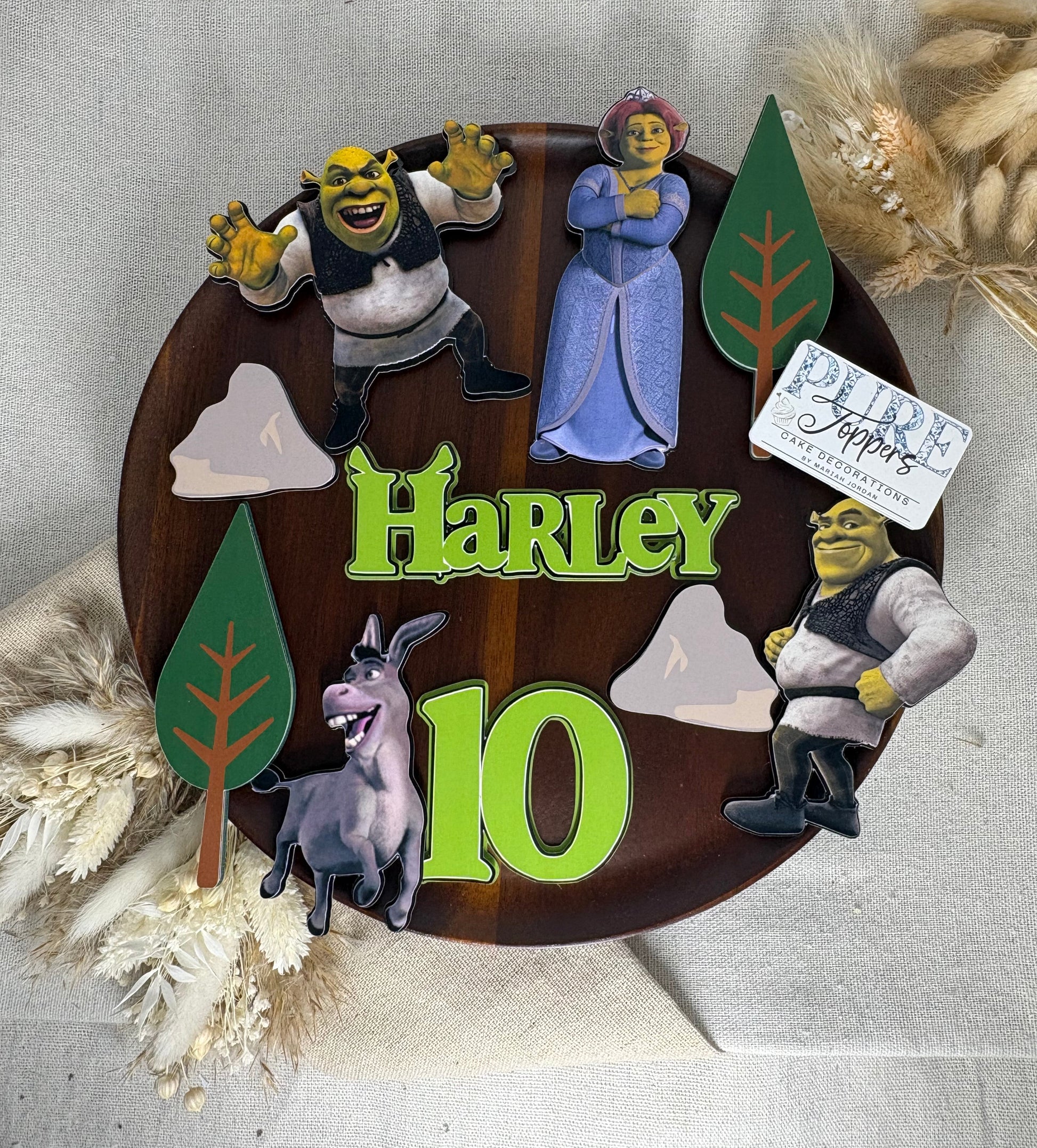 Personalised Shrek birthday cake decorations with layered Shrek, Fiona, Donkey and flexible cake topper placement.