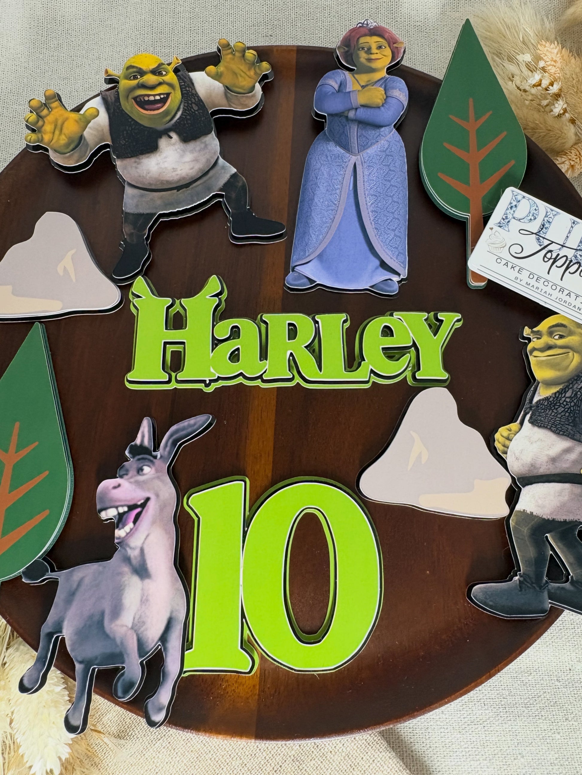 Layered Shrek cake topper set featuring personalised name and age with Shrek, Fiona and Donkey birthday cake decorations.