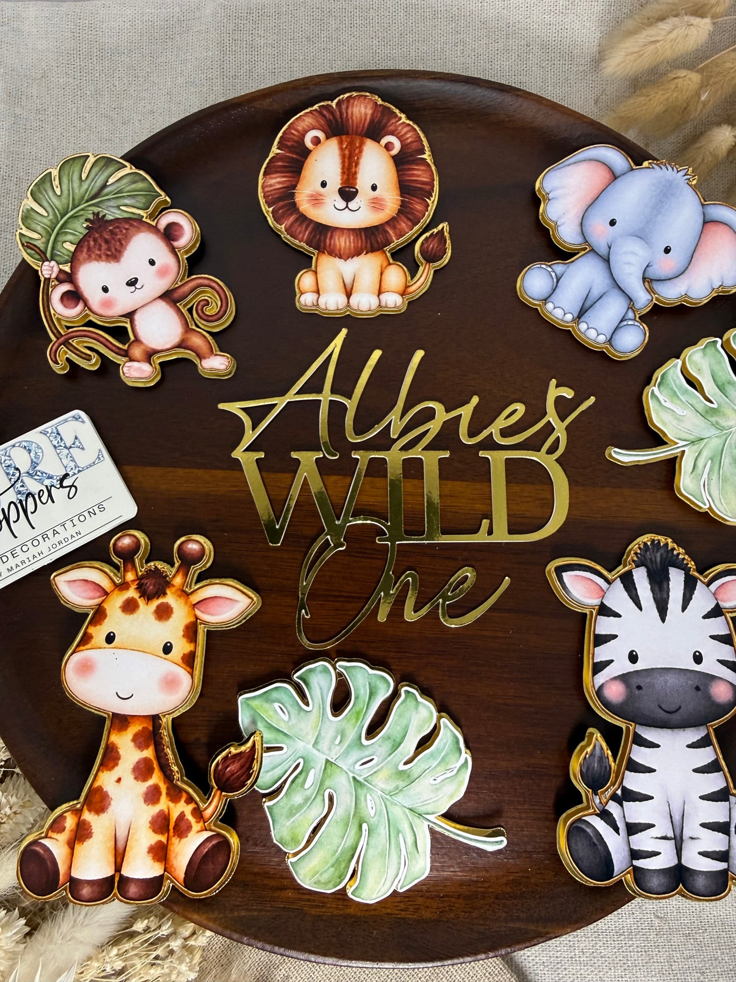 Wild One first birthday cake topper with personalised name and safari animals