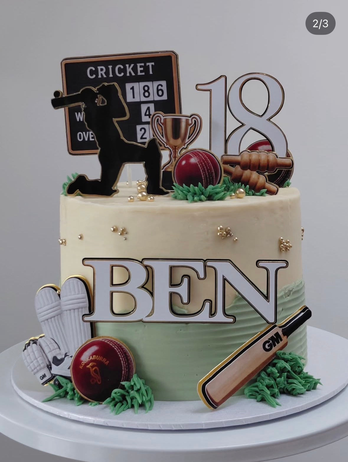 Personalised triple-layered cricket birthday age topper attached to a cake topper stick