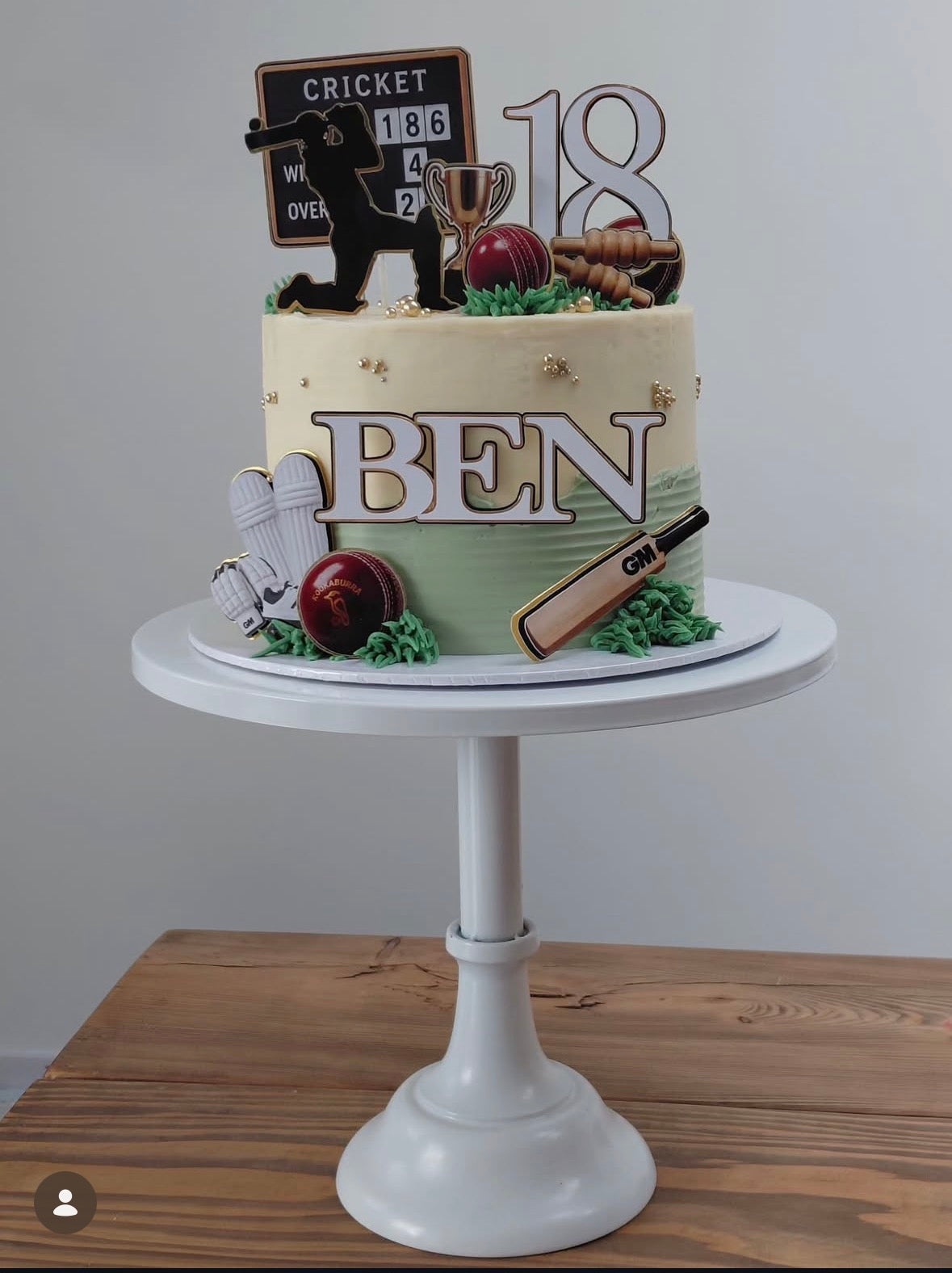 Individual cricket birthday cake decorations including cricket bats, balls, shin pads and player silhouette