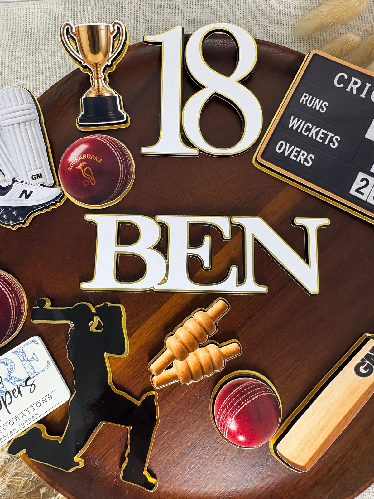 Triple-layered cricket shin pads decoration from a personalised cricket cake topper set
