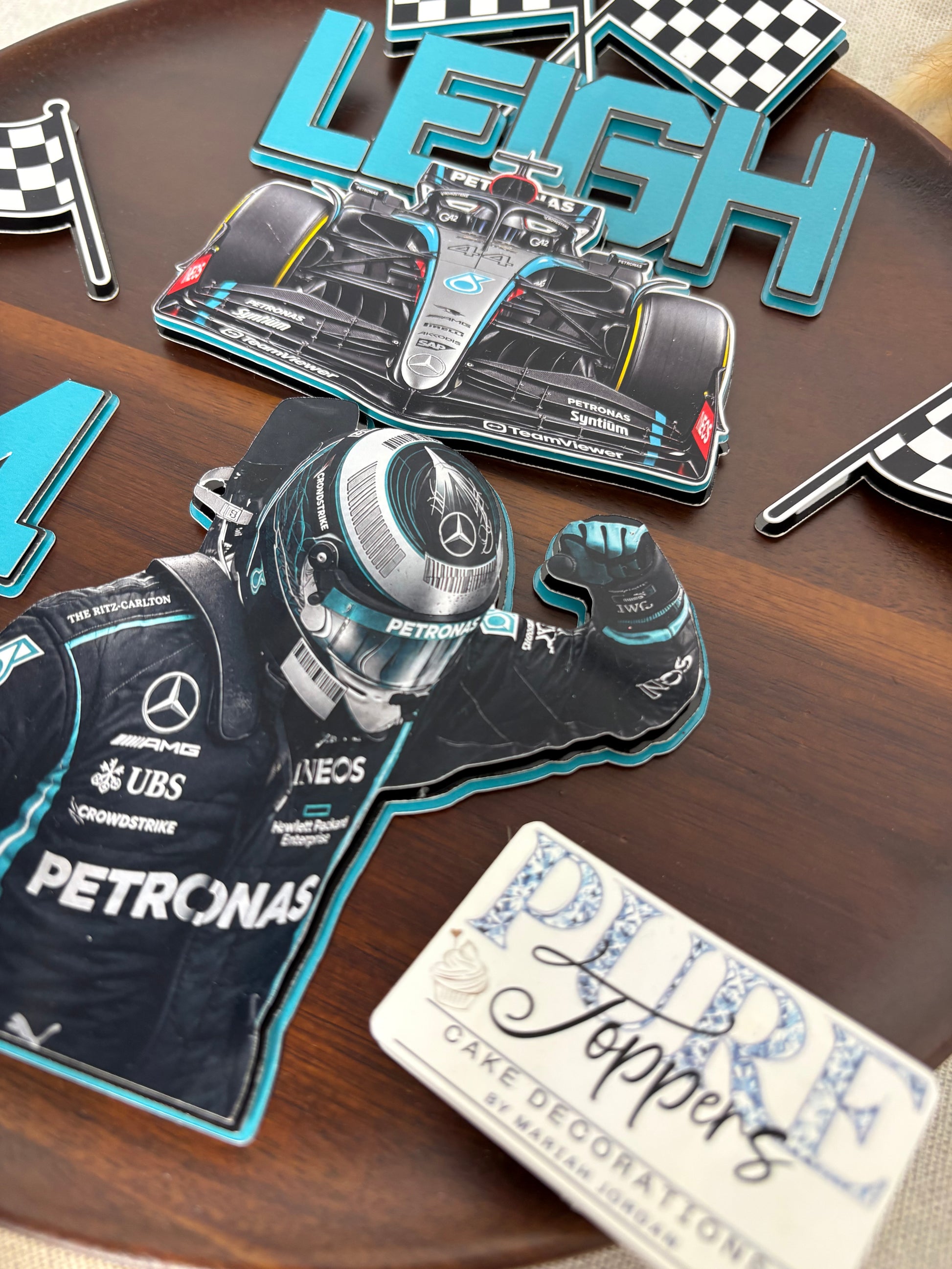 Colour matched layered personalised name topper for a Formula 1 inspired birthday cake