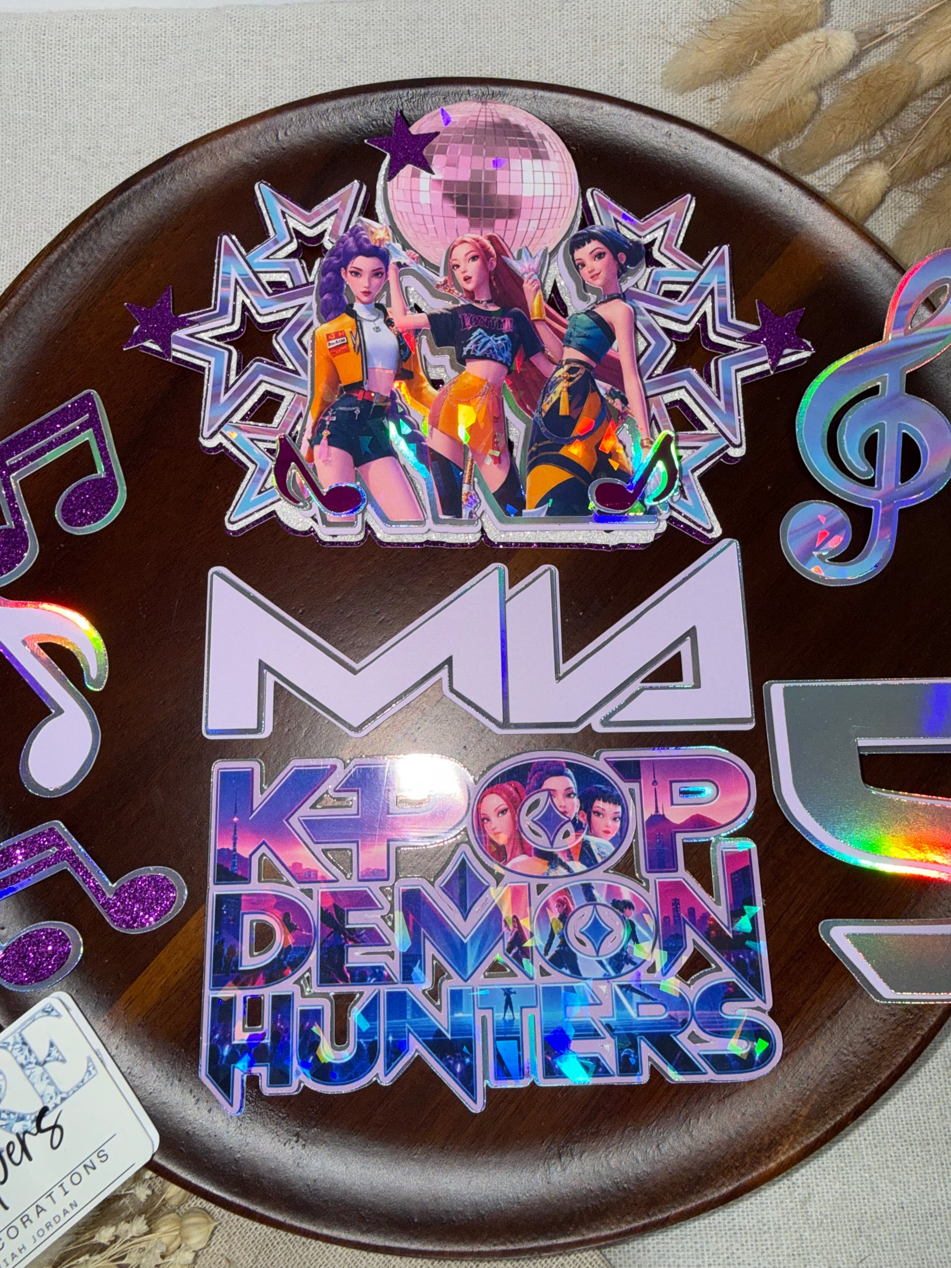 KPop Demon Hunters birthday cake decorations with music note charms