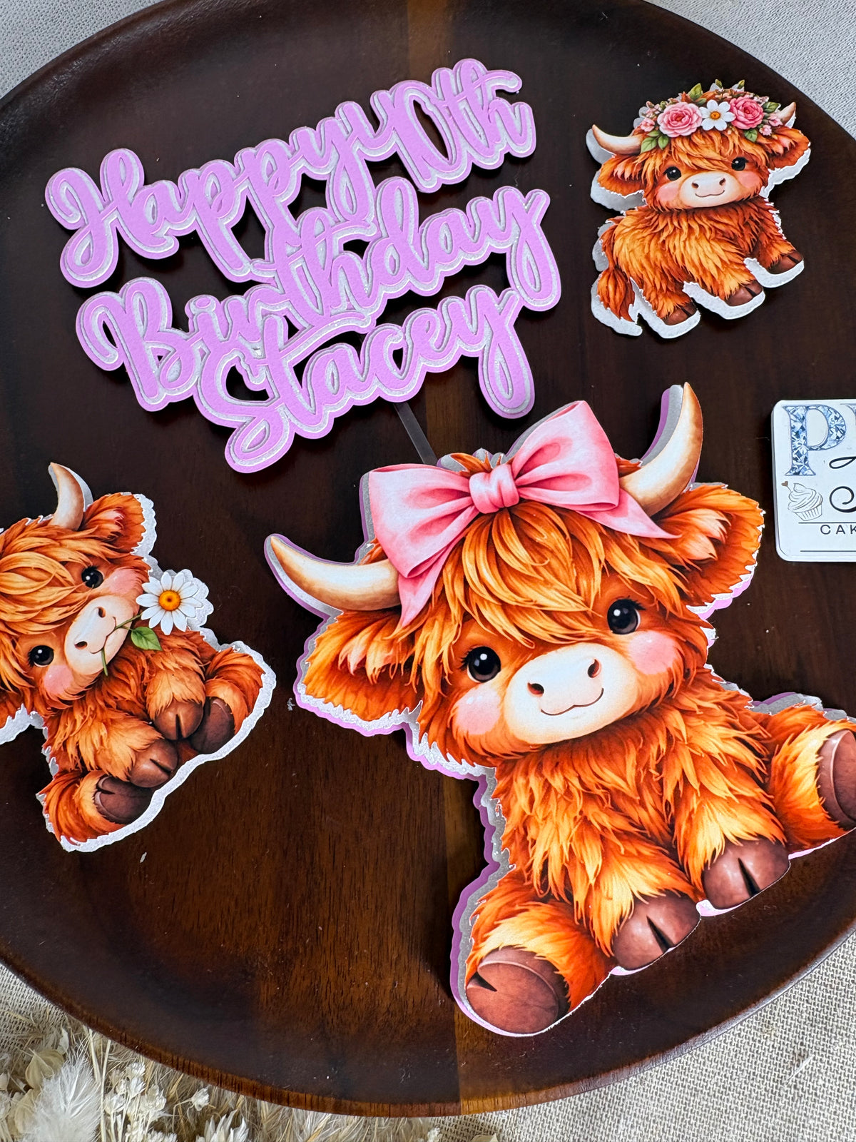 Large cute triple-layered Highland cow decoration designed for the centre of a birthday cake