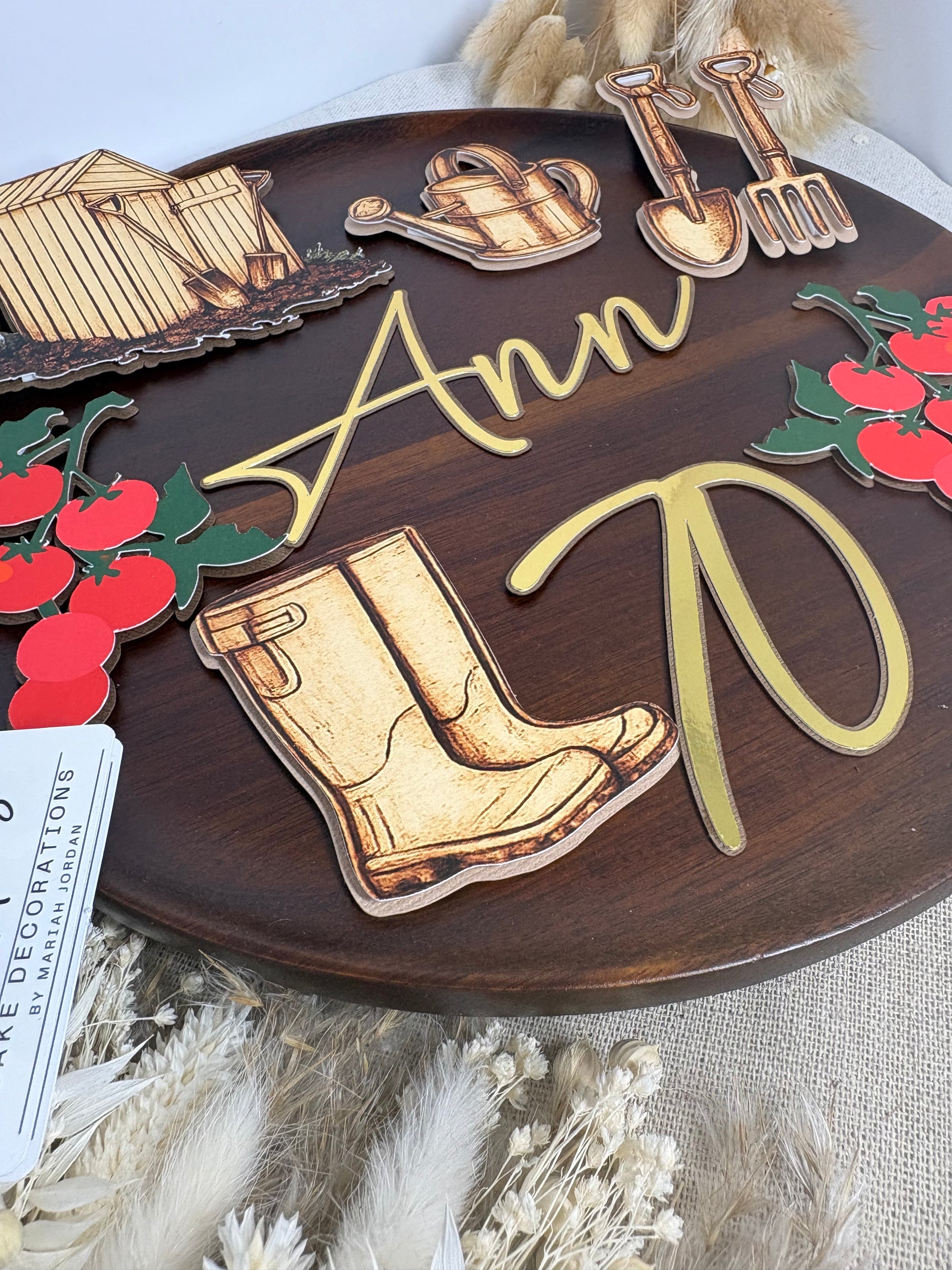 Personalised allotment cake topper set with garden shed, watering can, tomato vines and gardening tools.