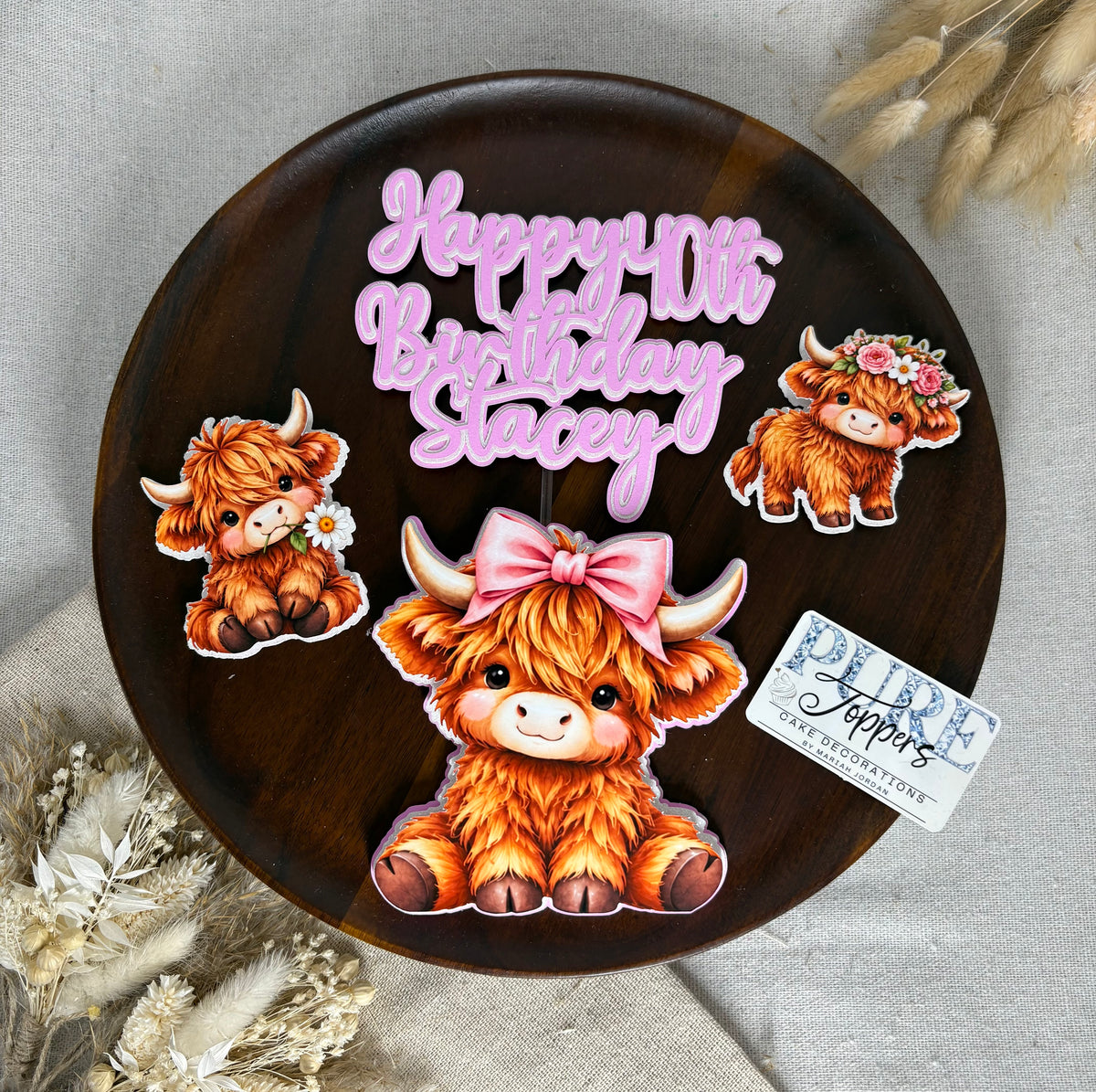 Personalised Highland cow cake topper set with pink and white birthday lettering and three cute Highland cow decorations