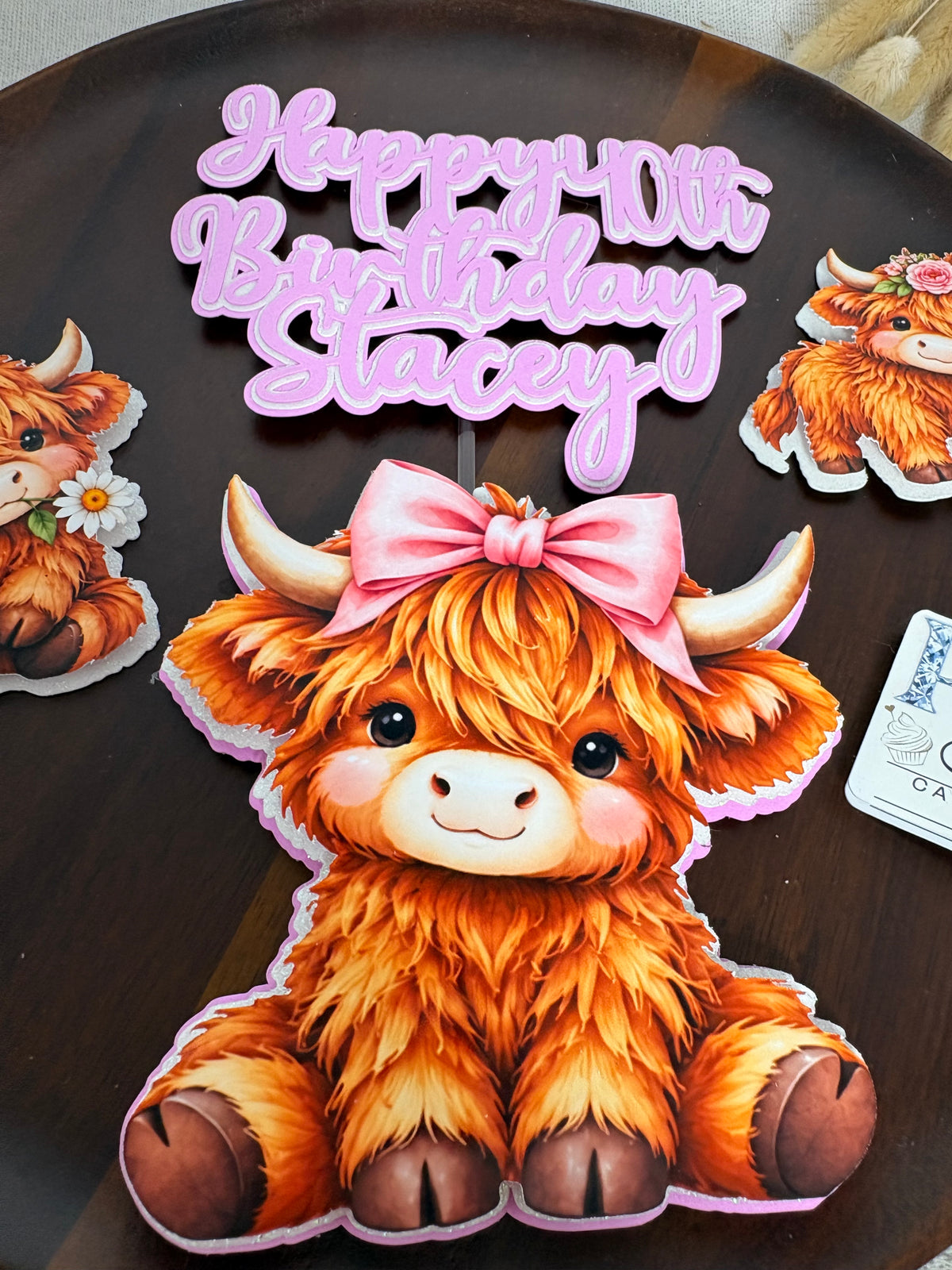 Close-up of personalised triple-layered pink and white birthday cake topper lettering